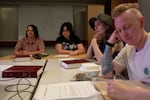 From left, Sah Hanna, Delilah Poehner, Robin Tanager and Quill Onstead listen and take notes during during queer torah study.