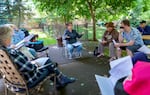 Margot Black, center, leads a meeting of the Woodspring Tenants Organizing Committee to keep Woodspring Apartments affordable for seniors in Tigard, last week.