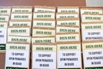 Clipboards for volunteers supporting the Idaho nonpartisan primaries ballot initiative fill a table during a gathering at Ivywild Park in Boise on April 27.