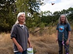 David James, left, and Ida Galash watch as a Monarch butterfly fitted with an electronic tag takes flight. For decades, James has been tagging Monarchs with paper tags, which can only provide migration data if found.