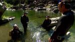 Sophie Price, Allen Crockett, Owen Harling, and Will Harling circle up to compare their fish counts at the bottom of a pool.