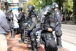 Police in riot gear respond to a protest outside Portland City Hall.