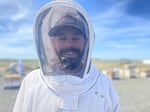 Brandon Hopkins, 42, with Washington State University, stands in front of the university’s bee colonies at a facility in Othello, Wash., where he and a team were examining the hives.