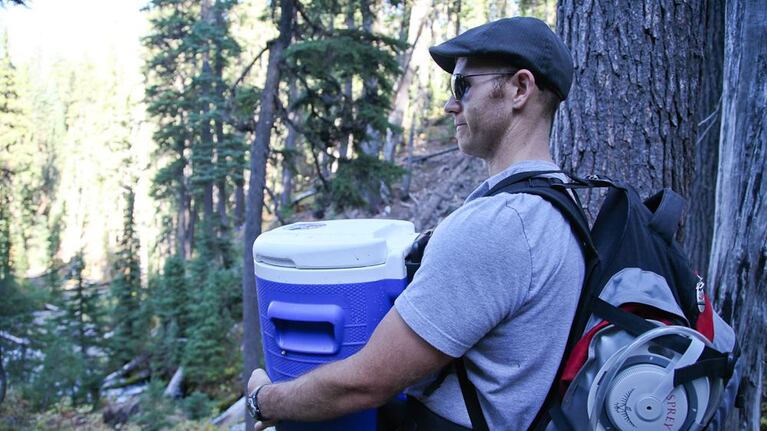 Steven Wyatt carries a 5 gallon cooler full of spring water from Boundary Springs. Wyatt enjoys brewing with spring water.