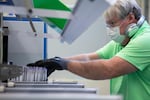 An elections worker sorts ballots at the Multnomah County Elections Division in Portland, Ore., Wednesday, May 13, 2020. Oregon elections officials and experts are confident COVID-19 adjustments will not alter the integrity of the primary.