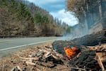 Logs burn alongside Highway 224 near Estacada, Ore., Sept. 24, 2020.