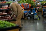 A worker places a price for vegetables inside the Walmart Supercenter in North Bergen, Thursday, Feb. 9, 2023, in New Jersey.