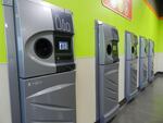 A row of sparkling clean reverse vending machines greet customers at the grand opening of the Medford BottleDrop center.