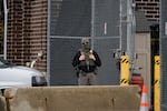A federal agent stands outside the U.S. Immigration and Customs Enforcement building Wednesday, Oct. 15, 2025, in Broadview, Ill.