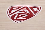 FILE: A Pac-12 logo is shown on the floor of Maples Pavilion during an NCAA college basketball game between Stanford and Arizona in Stanford, Calif., Feb. 23, 2024.