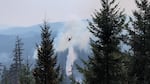 A helicopter drops water on the Chalk Fire burning in the Willamette National Forest east of Eugene, Ore., in this handout photo Thursday, Sept. 5, 2024.