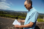 Fruit grower Brian Nakamura holds a 2001 newspaper clipping from The Oregonian that spurred him and fellow growers to launch a voluntary effort to reduce pesticide pollution in Hood River Valley streams.