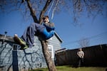 Colin, 12, swings in the backyard of his family home in Vancouver, Wa., while his father, Adam Bailey, pushes him on Saturday, March 2, 2019. The repetitive action of swinging helps Colin, who has autism, calm down.