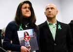 At a press conference one month after the shooting, Jennifer Hensel holds a portrait of her daughter, Avielle Rose Richman, who was among those killed at the Sandy Hook Elementary School. Beside her is her husband, Jeremy, who worked tirelessly for brain research into the causes of violence. Jeremy took his own life in 2019.