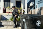 A New Orleans police officer searches the area near a crime scene after a vehicle drove into a crowd on Canal and Bourbon Street earlier, Wednesday Jan. 1, 2025.