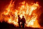 FILE — Fire crews battle the Kenneth Fire in the West Hills section of Los Angeles, Thursday, Jan. 9, 2025.