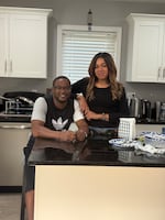 Samuel and his wife Latavia Kangethe pose for a portrait in their home in Lansing, Mich., on July 3, 2025.