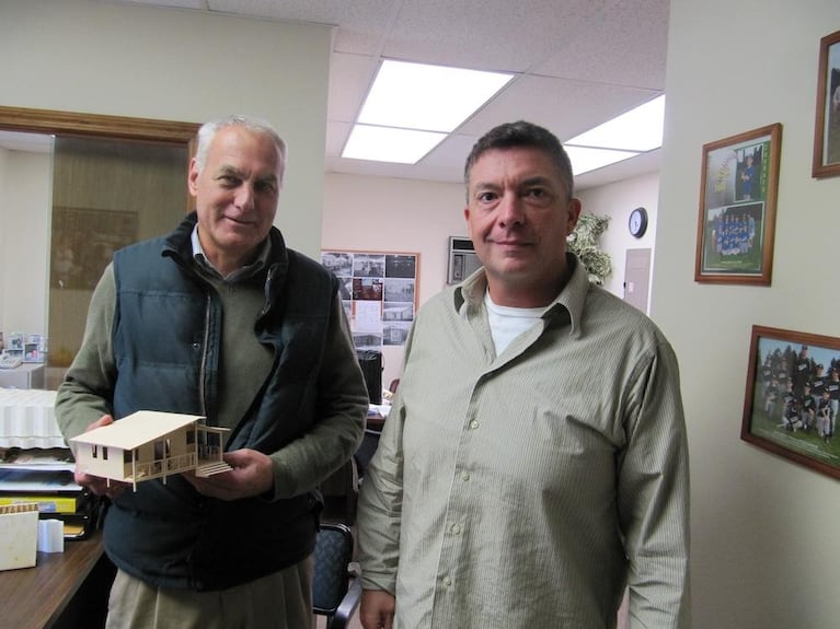 Pacific Green Innovations   CEO Charles Fox (right) and COO John Moore showing off one of the preferred housing designs for Haiti homes. 