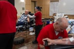 Mariano Masolo, left, gets ready to donate blood to the American Red Cross at Portland Fire & Rescue Station 1, in Portland, Ore., Sept. 11, 2026, commemorating the Sept. 11, 2001 terrorist attacks. Masolo, who lived in his native Italy at the time, recalls seeing the words, “Siamo tutti Americani”, which translates to “we are all Americans”, on the front page of a major Italian newspaper the day after the attacks.