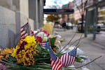 A makeshift memorial of flowers and American flags stands outside the Farragut West Metro station on Saturday in Washington, D.C.