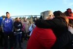 Michele Thompson, Carlos Hunter's former partner and mother to his seven-year-old son Gabrial, embraces family and friends at a vigil. 