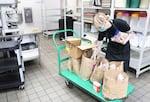 Shannon Chasteen sorts through a new donation at Blanchet House in Portland.
