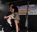 Michael Spera, left, and Sabrina Yaranon embrace on stage after getting engaged in a surprise proposal.