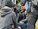 People help someone who got pepper-sprayed in the face at the Portland State University campus on Thursday, May 2, 2024. Portland police formed a perimeter early in the morning around the school's library to remove people protesting Israel's role in the war in Gaza.