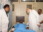 This handout photo issued by the Indian Ministry of Home Affairs shows Home Affairs Minister Amit Shah meeting British plane crash survivor Vishwash Kumar Ramesh, 40, at a hospital in Ahmedabad, after Air India confirmed Mr Ramesh was the sole survivor of the 242 people on board the London-bound Boeing 787 Dreamliner when it crashed into a medical college shortly after take-off from Ahmedabad airport.