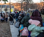 A crowd of people stand in line at the No Limits Food Pantry for free groceries.