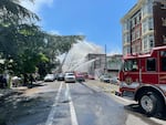 Crews work to extinguish a fire in a four-story apartment building in downtown Portland, Ore., May 16, 2023.