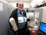 The founder of 'Vets Helping Vets HQ' Victor Kuhns holds the two law books that veterans have to follow in order to secure their benefits.