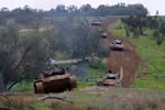 A unit of Israeli soldiers return to the Israeli side of the border with the Gaza Strip on Jan. 28, after spending months in the Palestinian enclave engaged in battles with Hamas militants as the fighting between the two sides continues.