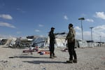 Members of the Syrian government forces stand at the empty Al-Hol camp, which was closed by the Syrian authorities on Feb. 25. Syria confirmed the mass escape of relatives of suspected Islamic State members from the Al-Hol camp last month following the withdrawal of Kurdish forces who had overseen the facility.