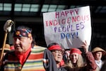 A sign is held aloft during an Indigenous Peoples Day march Monday, Oct. 9, 2017, in Seattle. In 2014, the Seattle City Council voted to stop recognizing Columbus Day and instead turned the second Monday in October into a day of recognition of Native American cultures and peoples.