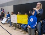 Crook County residents hold protest signs at a special school board meeting Jan. 6, 2025, when the board voted to negotiate terminating the superintendent's contract.