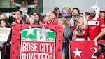 The Rose City Riveters erupt into cheers as the Portland Thorns emerge from the Portland International Airport Sunday, Oct. 15, 2017.