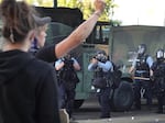 Police prepare to open fire with tear gas and nonlethal rounds on a group of demonstrators protesting the death of George Floyd on May 29, 2020, in Minneapolis, Minn.
