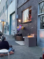 Oregon poet laureate Anis Mojgani talks to people on the street outside a studio he and a friend share.