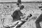 A South Vietnamese medic comforts a trooper wounded in the leg during a battle in Long An province southwest of Saigon on April 18, 1975. Fighting in the area, just north of the Mekong Delta, is on the increase.