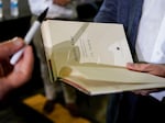 J.D. Vance autographs a book after a rally Thursday, July 1, 2021, in Middletown, Ohio.