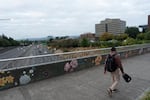 A person walks on a freeway overpass on Monday in Vancouver. 