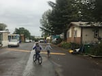 Adriel and Sammy Torres on their block in the Arbor manufactured home park.