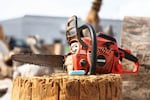 A chainsaw sit atop a stump at Rex Byers' woodshop in Reedsport