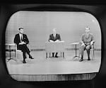 Moderator Howard K. Smith sits between, Sen. John Kennedy (left) and Vice President Richard Nixon as they appear on a television studio monitor during their debate in Chicago on Sept. 26, 1960.