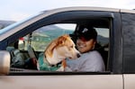 On April 26, 2025, a dog sits on its owner's lap at the First Nations Veterinary clinic on the Warm Springs reservation.