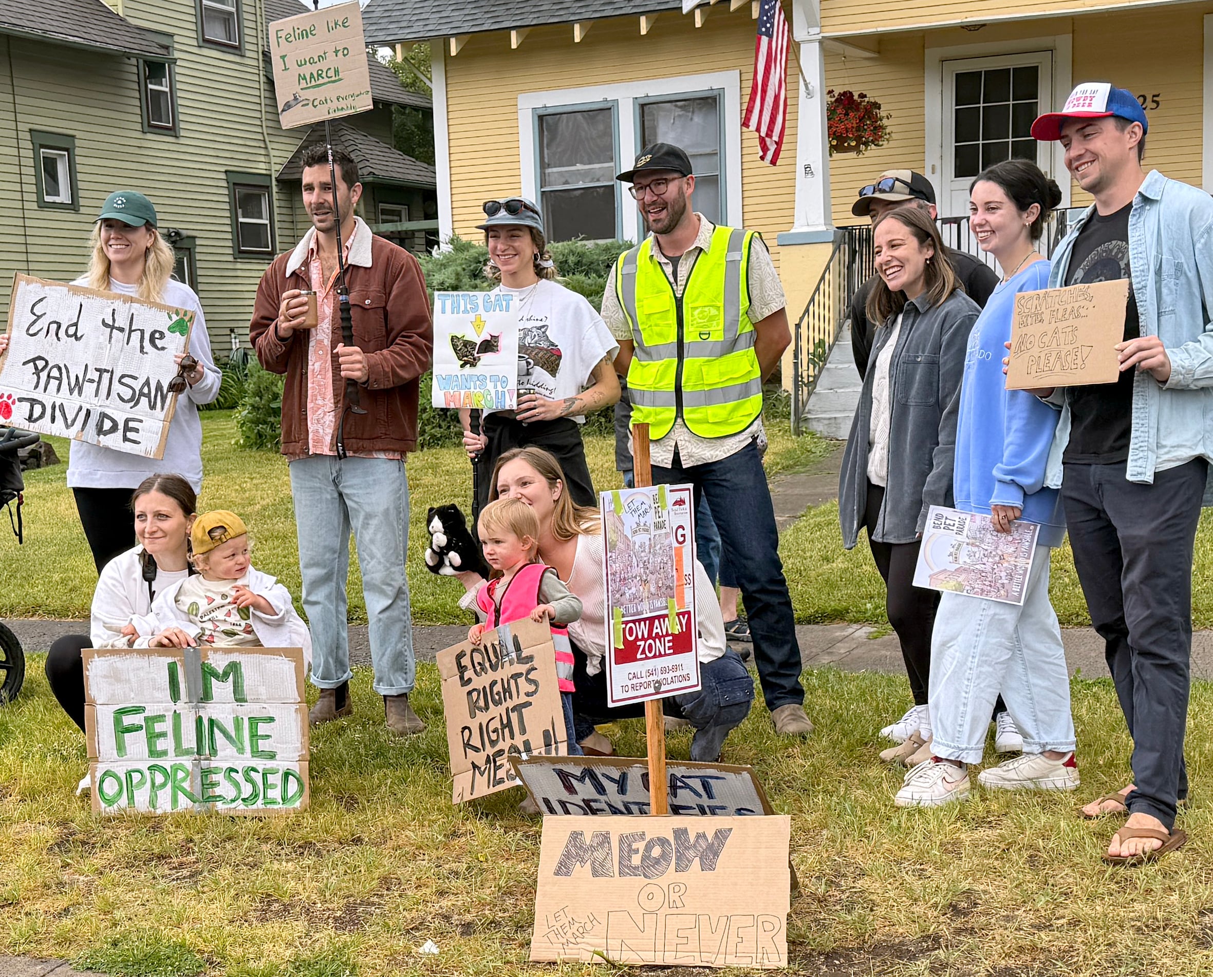 A group of cat rights protesters demonstrate at the Bend pet parade, July 4, 2025. Center with a blue hat with sunglasses on top is Zoie Meyers. She protested for her cat Onion to have the choice to participate in the parade. Bend Park and Recreation does not allow cats or rabbits at the event.