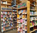 An interior shot of the romance section at Powell's. Several displays are in view, including "new and recommended romance" and "new and recommended poetry."