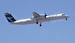 A WestJet airlines passenger plane, a De Havilland DHC-8-400 model, approaches Logan Airport in Boston, Thursday, May 24, 2018. (AP Photo/Charles Krupa)