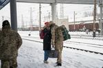 A soldier meets his partner at the train station in Sloviansk, in eastern Ukraine, ahead of Valentine's Day.